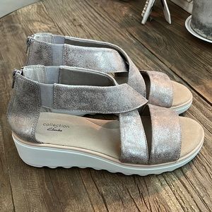 Women’s size 9 Wedge Sandal. Brand: Clark’s. Never worn, excellent condition.